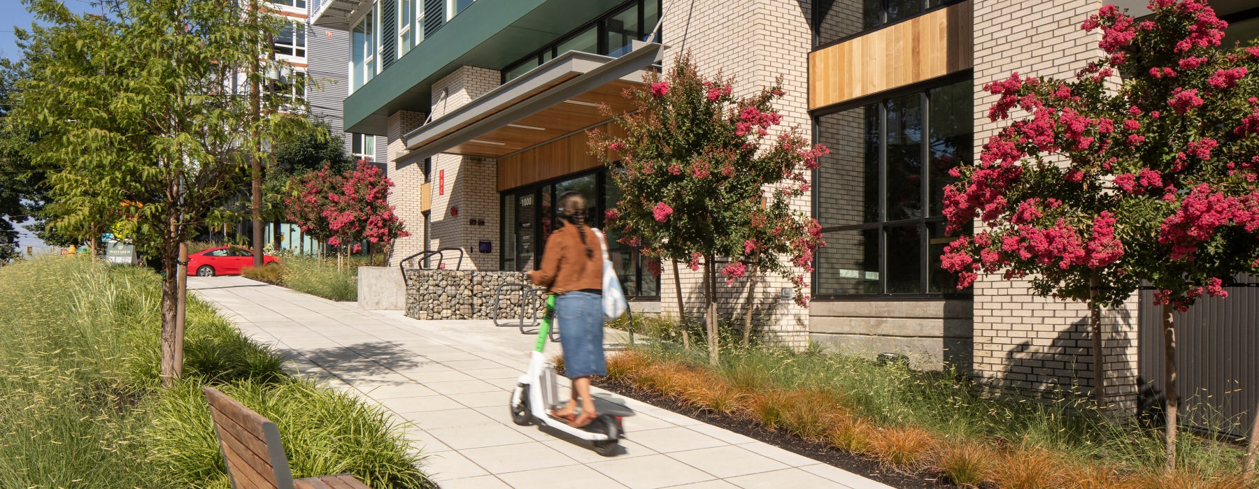 person riding scooter up a hill 